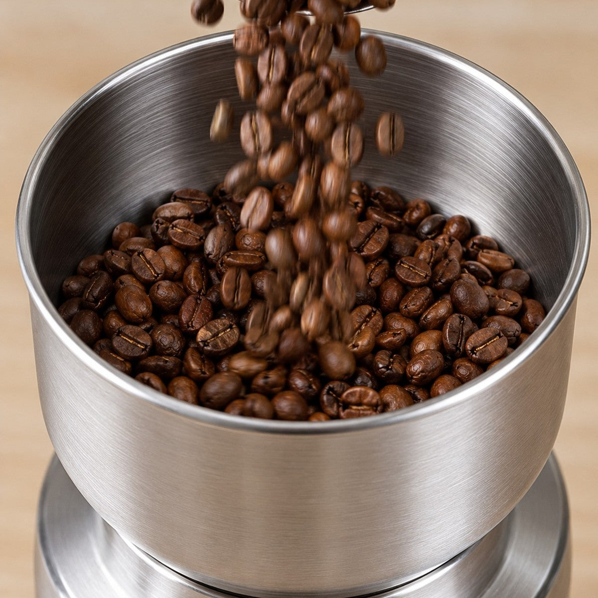 Beans pouring into the grinder bowl
