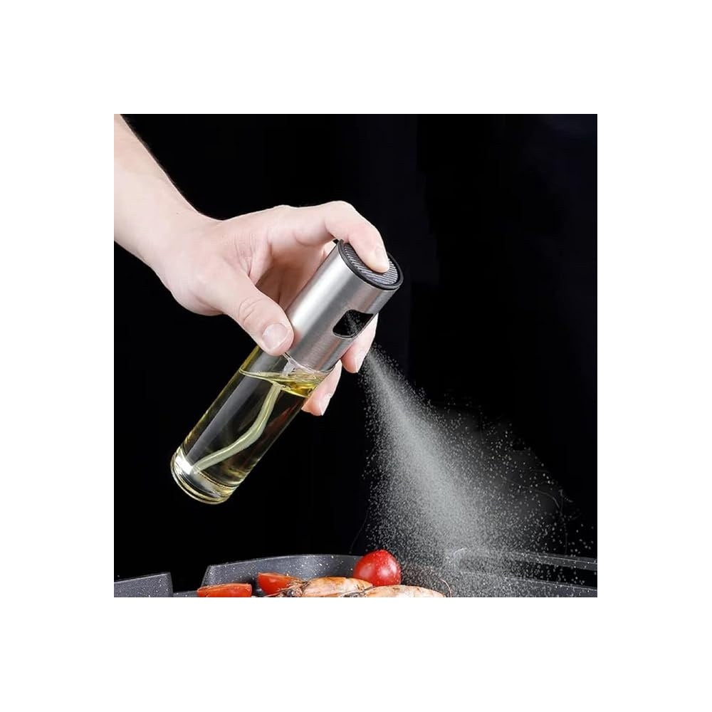 Oil sprayer misting oil over a pan